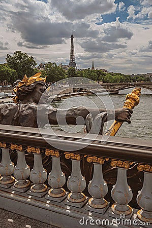 Golden statue on bridge at Seine River and Eiffel Tower in Paris Stock Photo